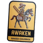 Awaken Baked Churros wanted sticker spotted in Edinburgh in 2025