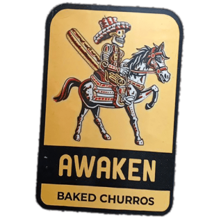 Awaken Baked Churros wanted sticker spotted in Edinburgh in 2025